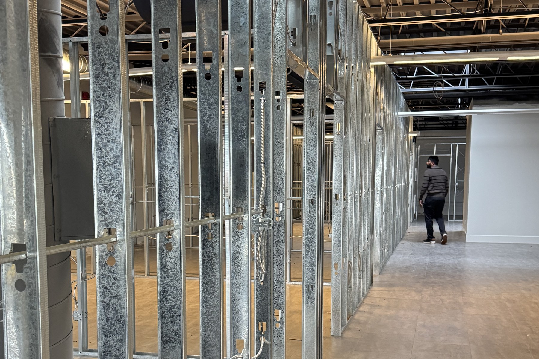 Framed corridor with electrical and service rough-ins in place