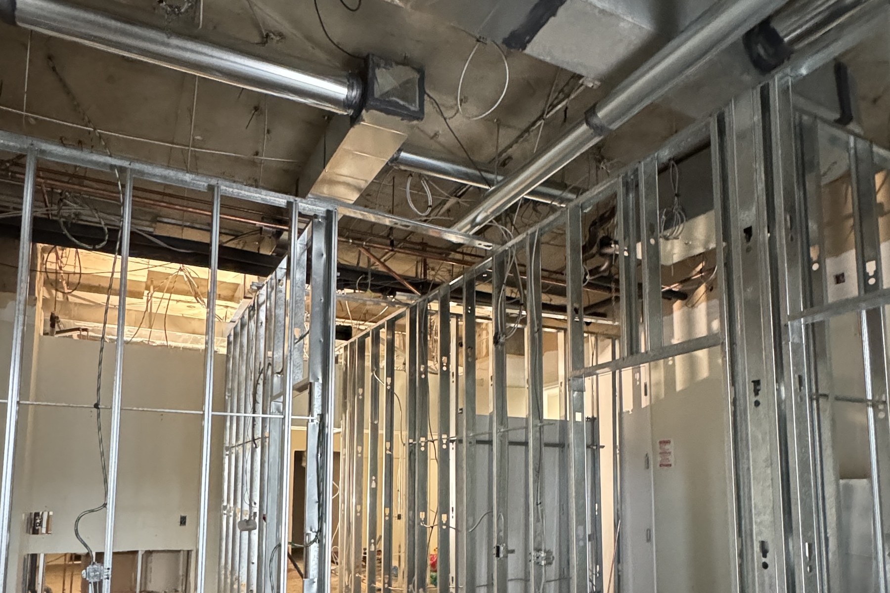 Treatment room framing with overhead ductwork and rough-ins, medical clinic fit-out in North York, Ontario