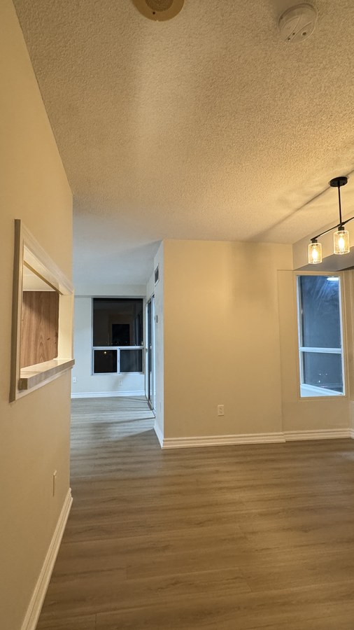 Finished interior renovation with new flooring, pass-through opening and pendant lighting