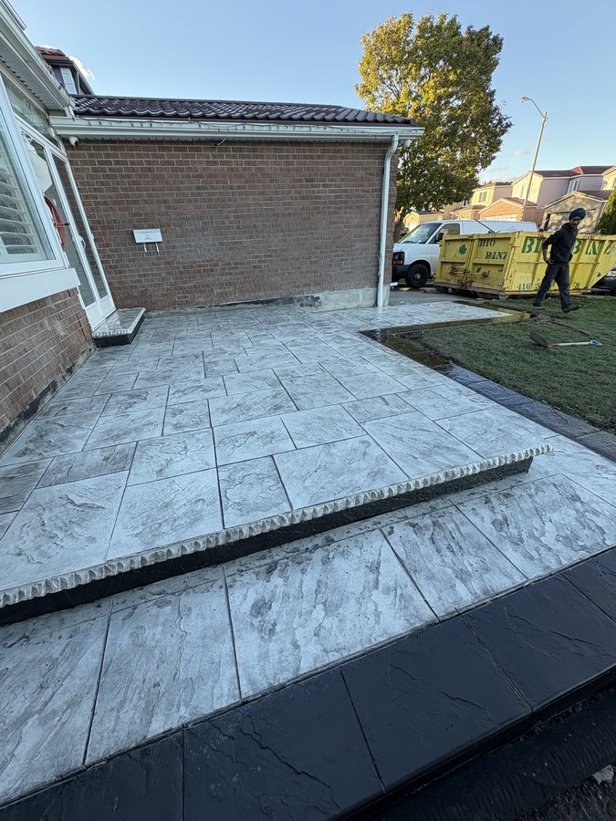 Stamped concrete steps and walkway at a garage entrance